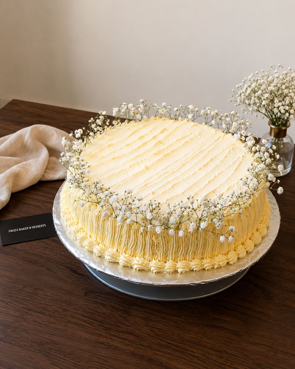 Large buttercream cake decorated with baby's breath flowers