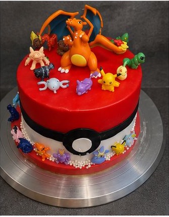 Red character theme cake with toy figures